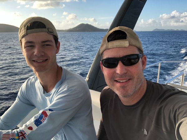 Father and son sailing together