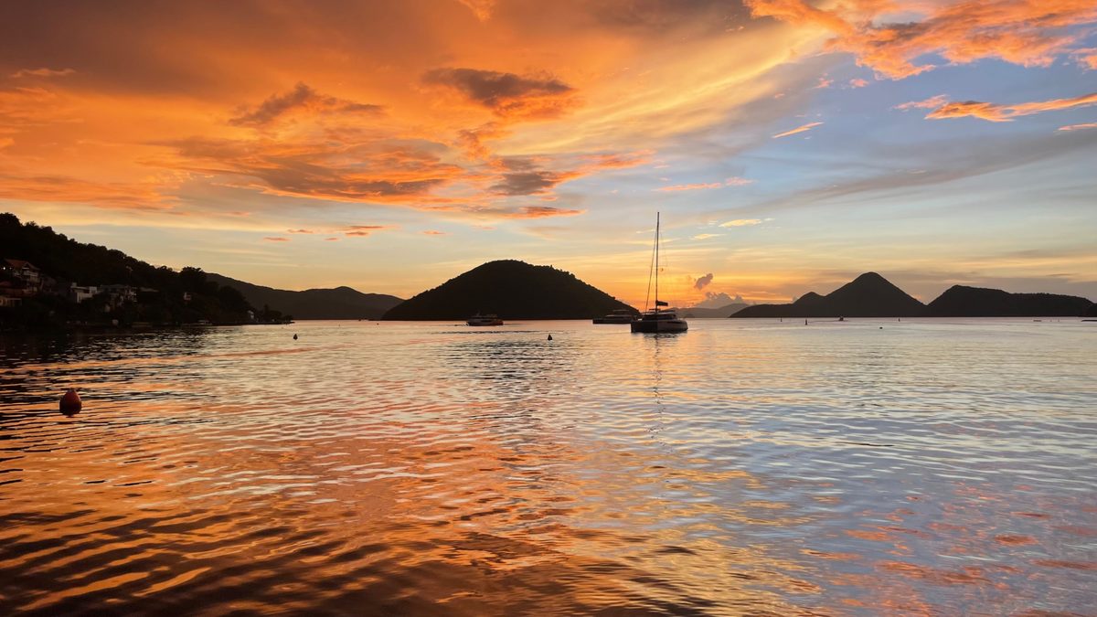 Catamarans in harbor at golden sunset